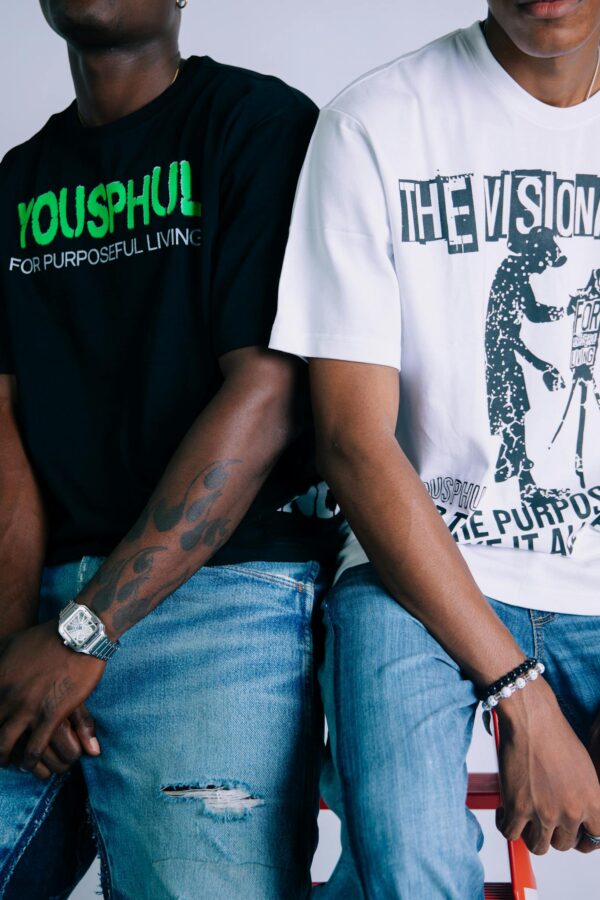 Stylish individuals in graphic tees and denim showcasing casual street fashion.